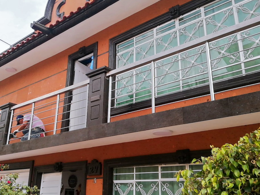 Barandal moderno de acero inoxidable en balcón de casa familiar en Estado de México